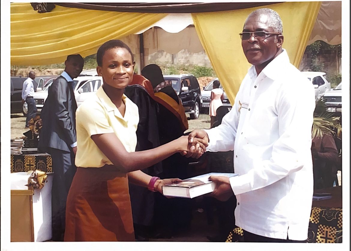 receiving award at Holy Child High School